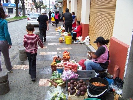 Women selling along the sidewalk in Cuenca